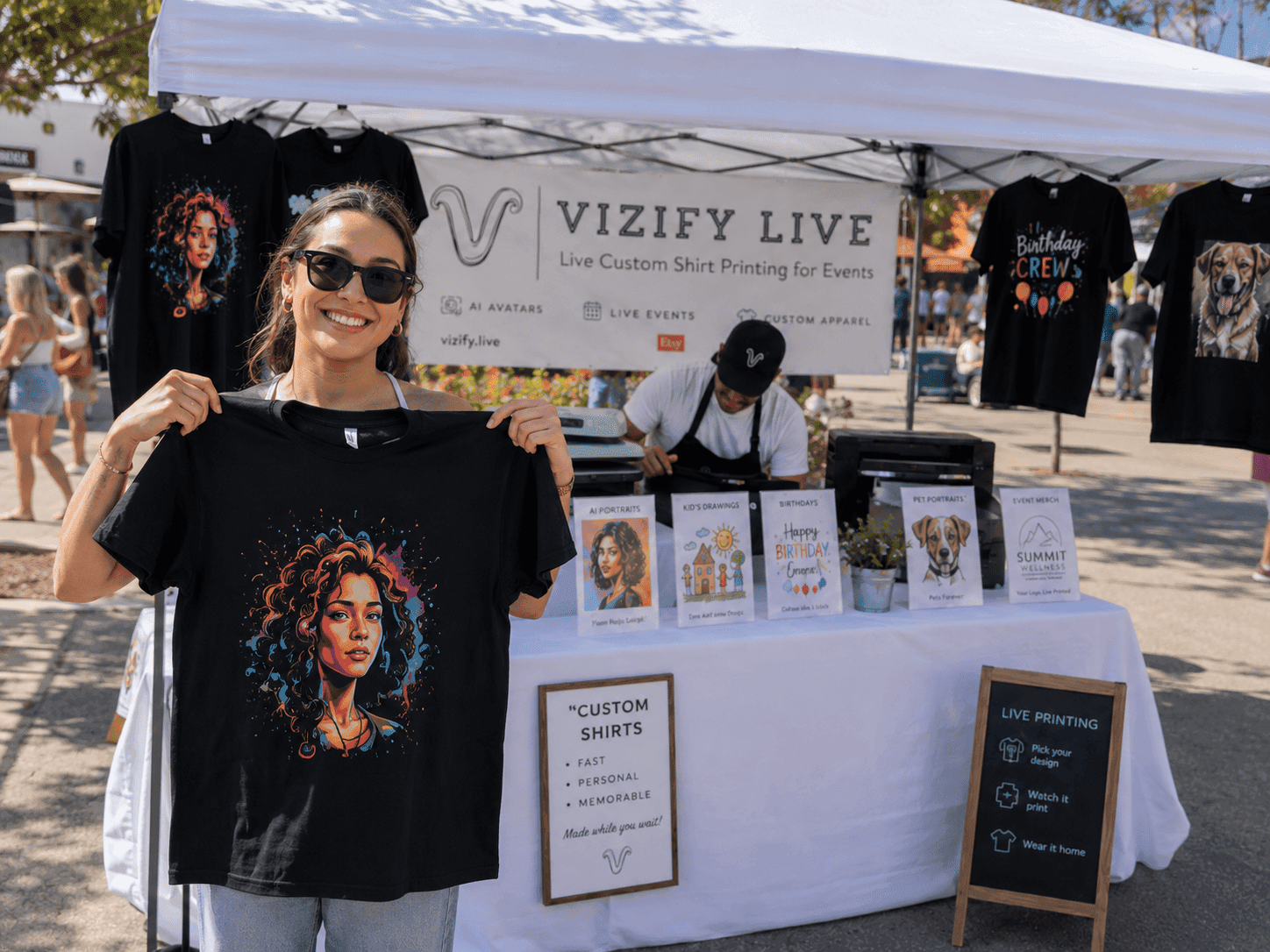 Smiling guest at the Vizify Live booth holding the AI portrait shirt they just designed